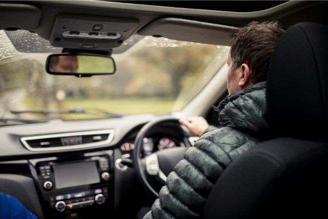 Person driving their car in winter