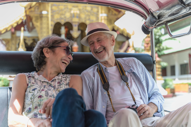 Smiling senior tourists in tuktuk