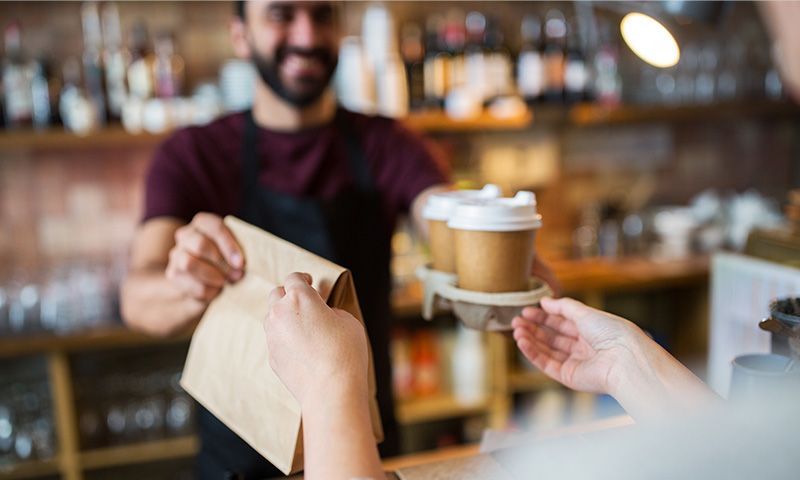 A Blue Light Card member buying coffee and breakfast