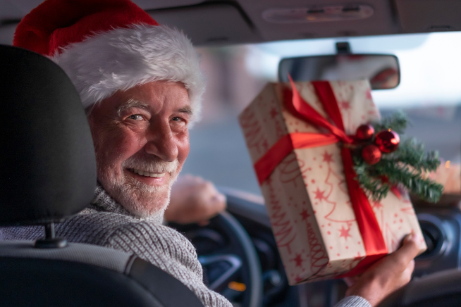 Man holding present in car