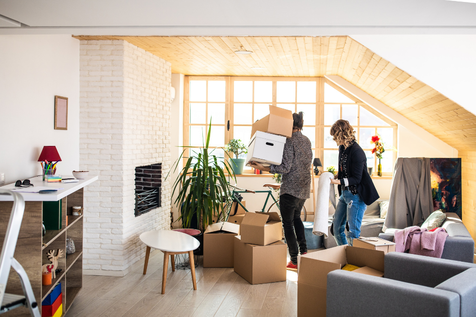 Two people packing and moving boxes