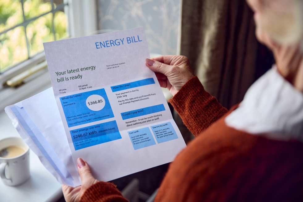 A woman holding her energy bill