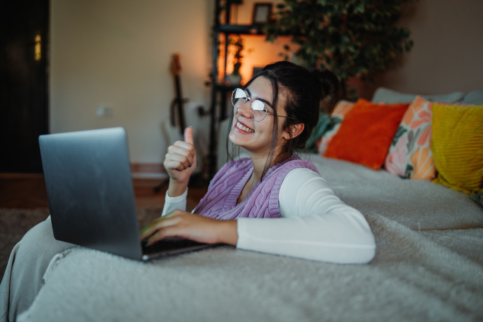 Woman looking happy at laptop