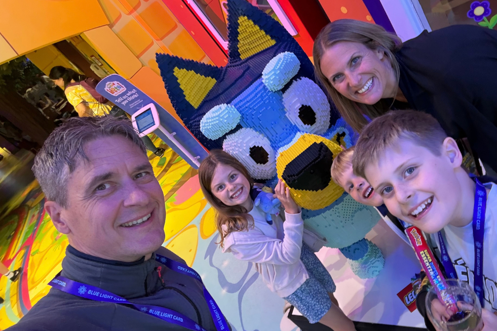 Family of five with a Lego Bluey statue