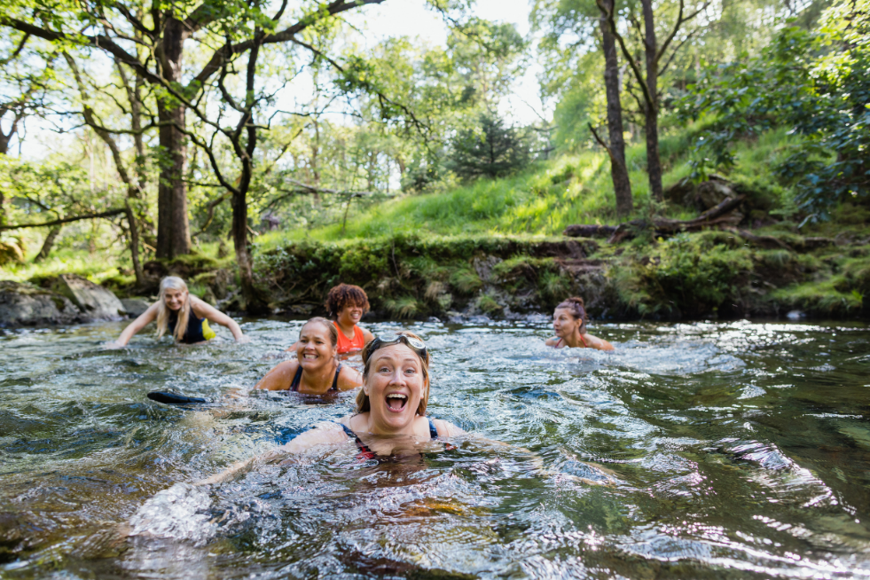 Five people swimming in a river