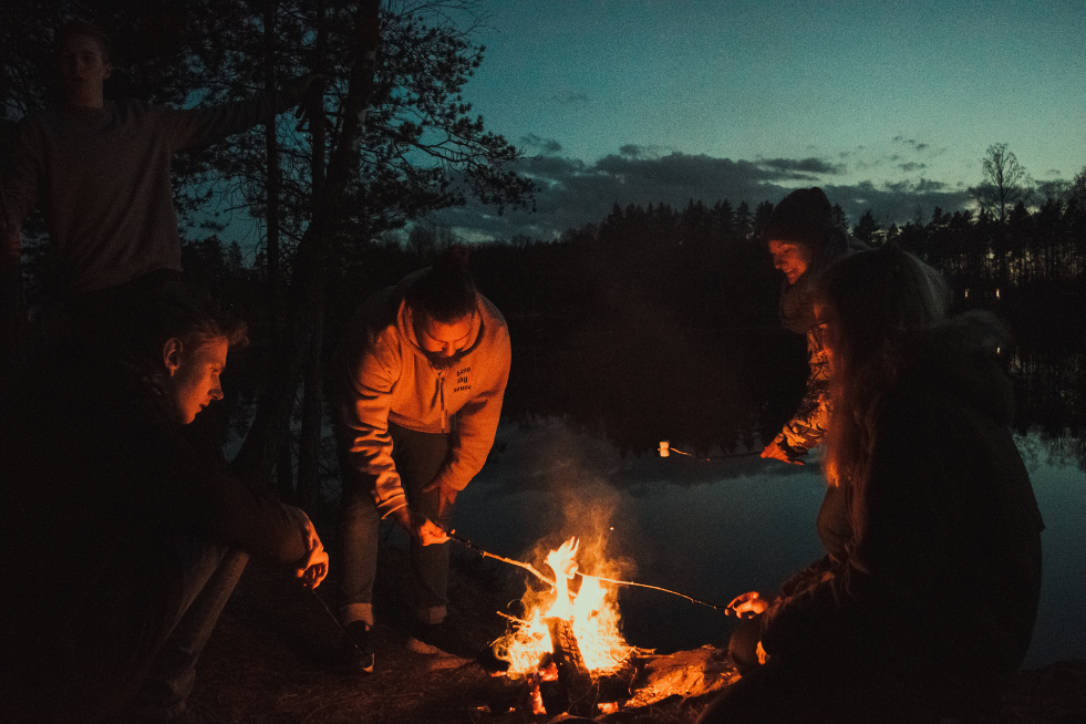 A group roasting marshmallows on a fire