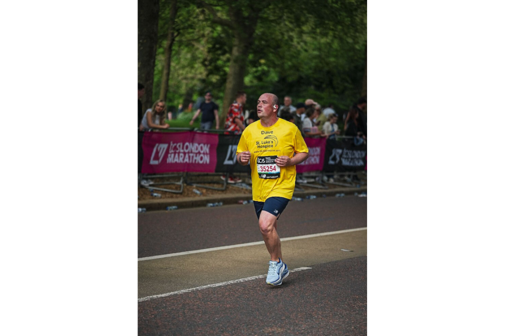 Dave wearing a yellow t shirt running the 2025 London Marathon