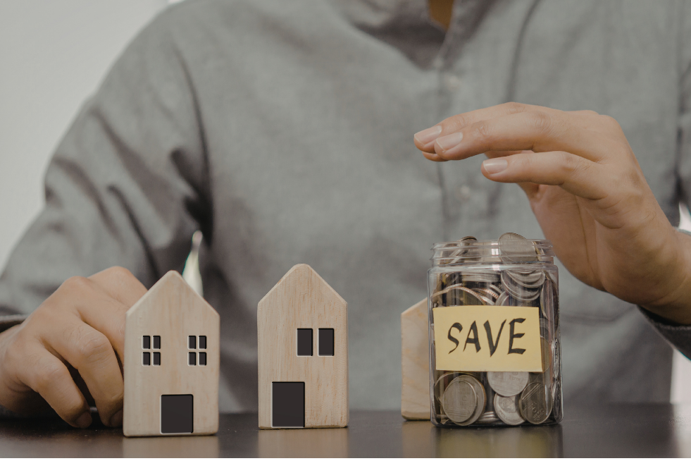 Model homes with a savings jar full of pennies 