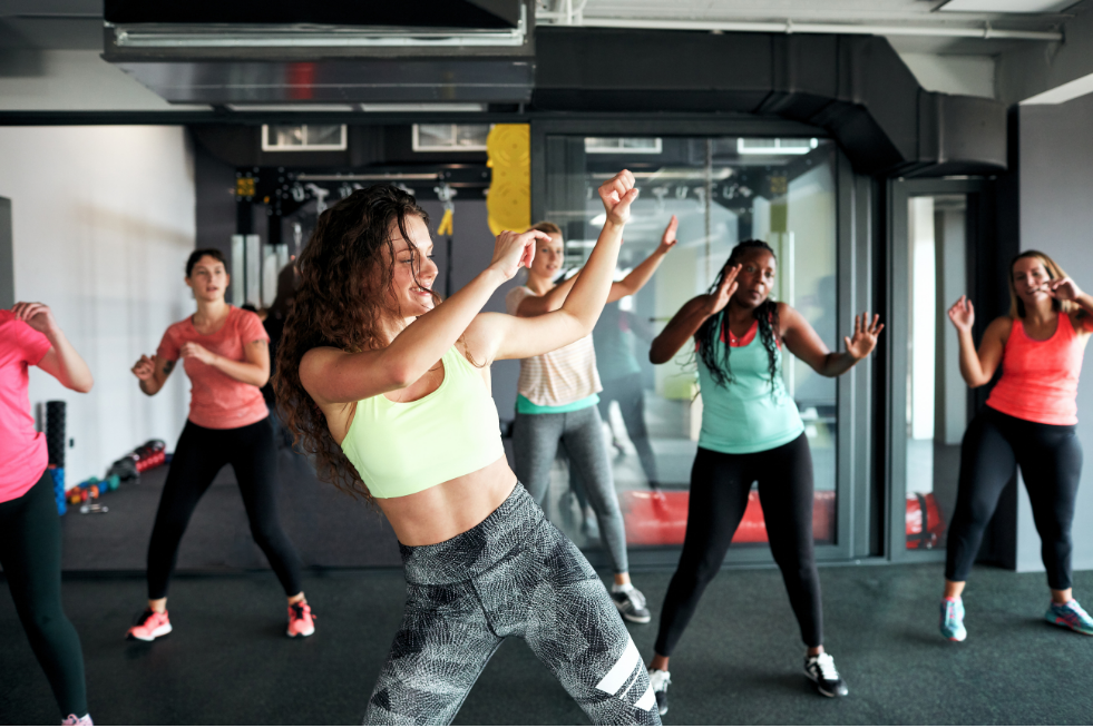 A group of women in a fitness studio dancing 