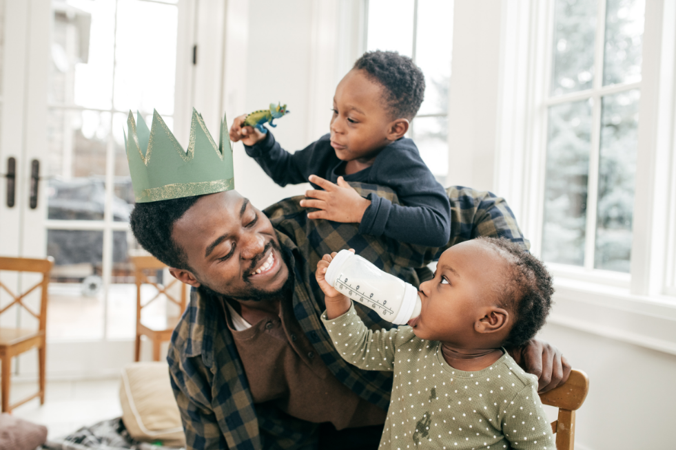 A dad playing with his young kids