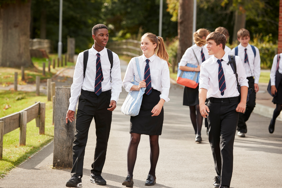 Three older school children in uniform