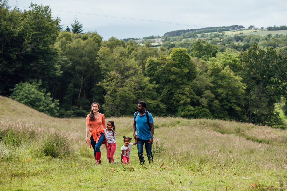 A family of four walking up a hill