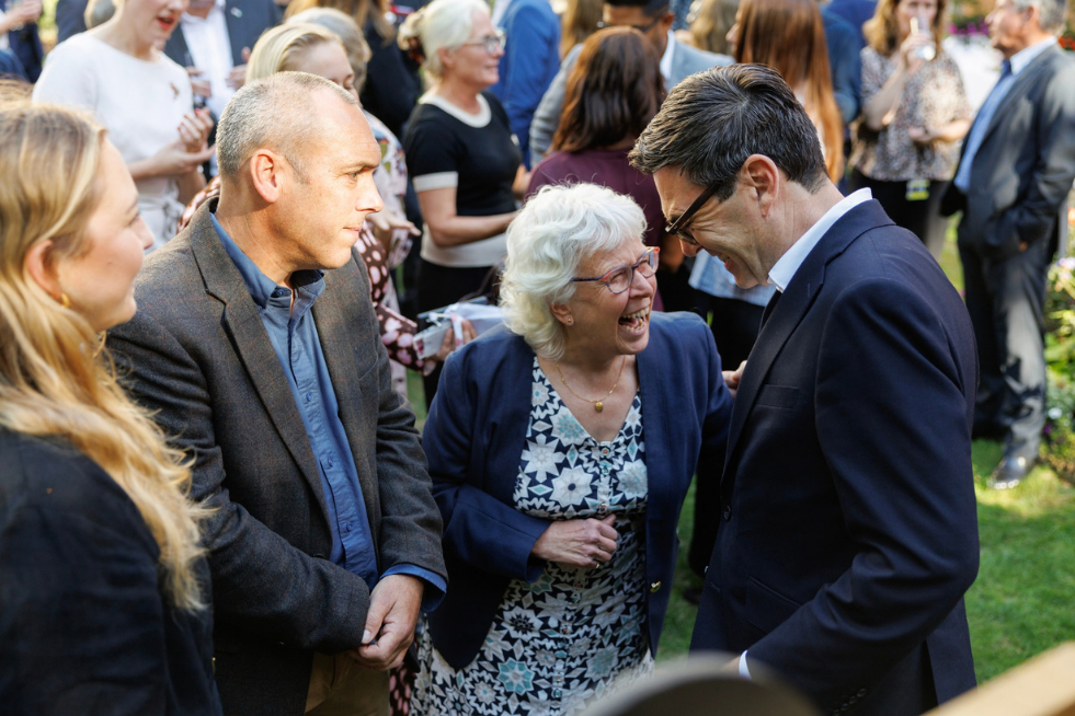 Andy Burnham laughing with guests