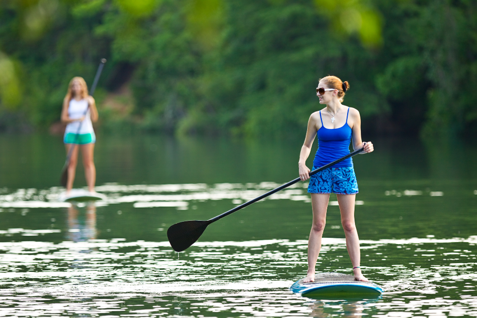 Woman on a stand-up paddle board on a lake