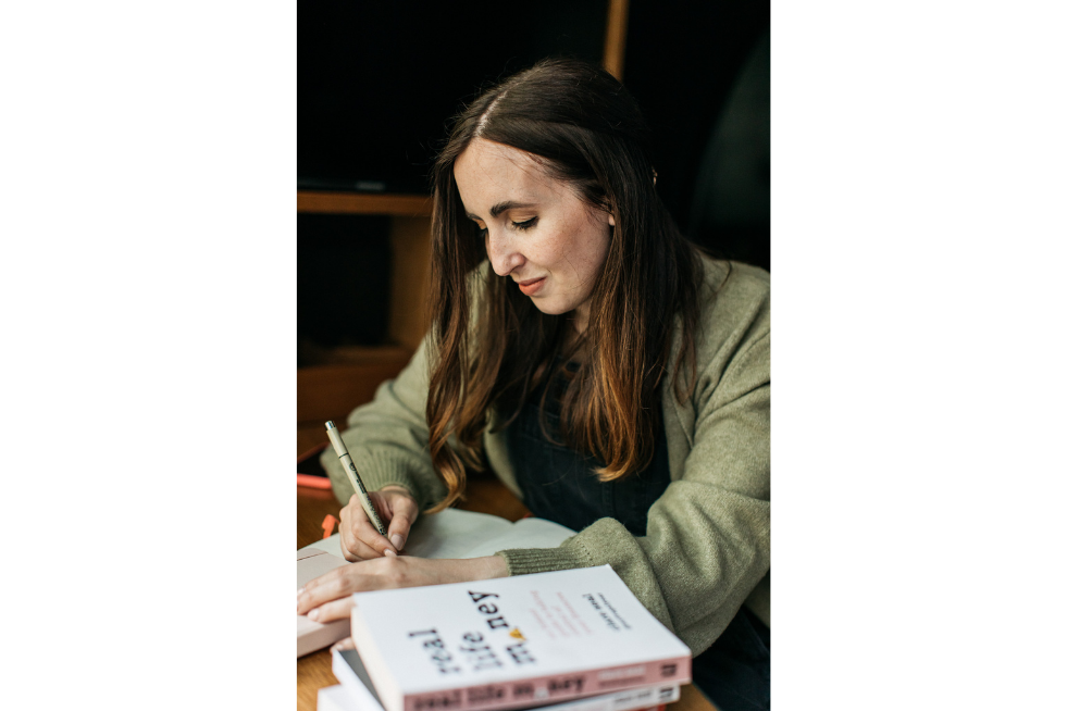 Clare Seal writing on a piece of paper