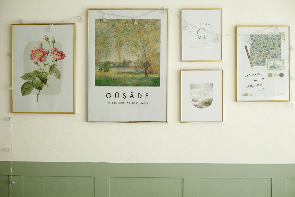 A gallery wall with green panelling below 