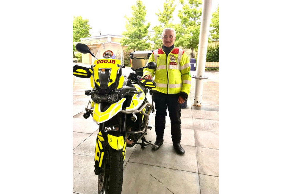 A Blood Bikes volunteer with a bike