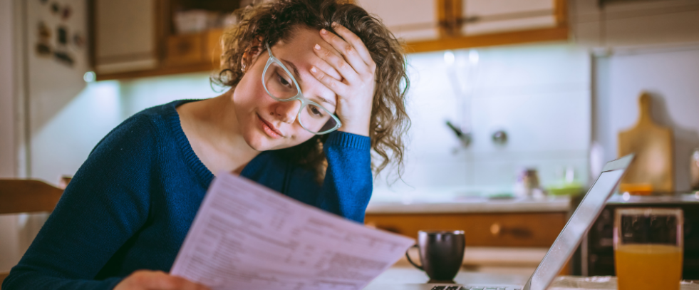 A woman looking at bills