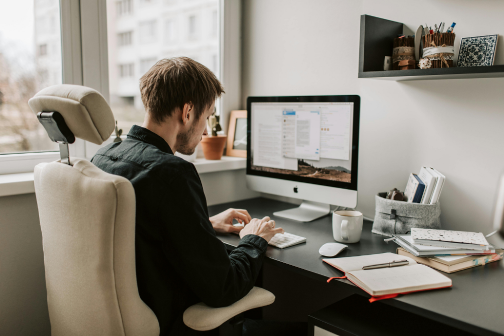 Man sat at a desk on a computer