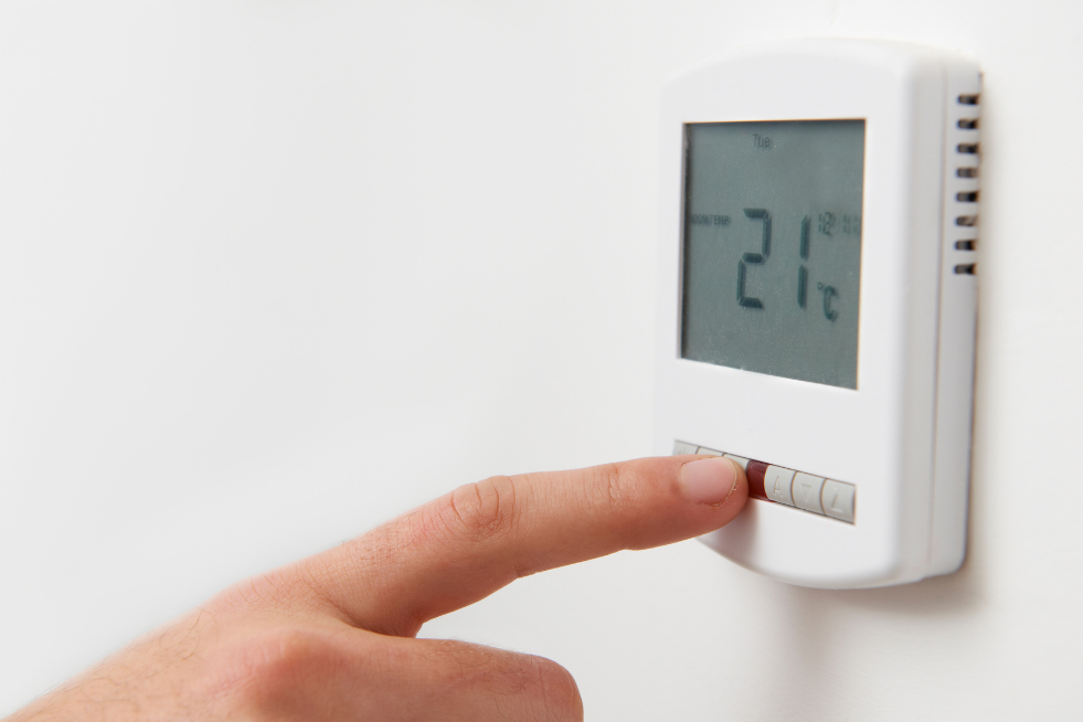 A thermostat on the wall set to 21 degrees