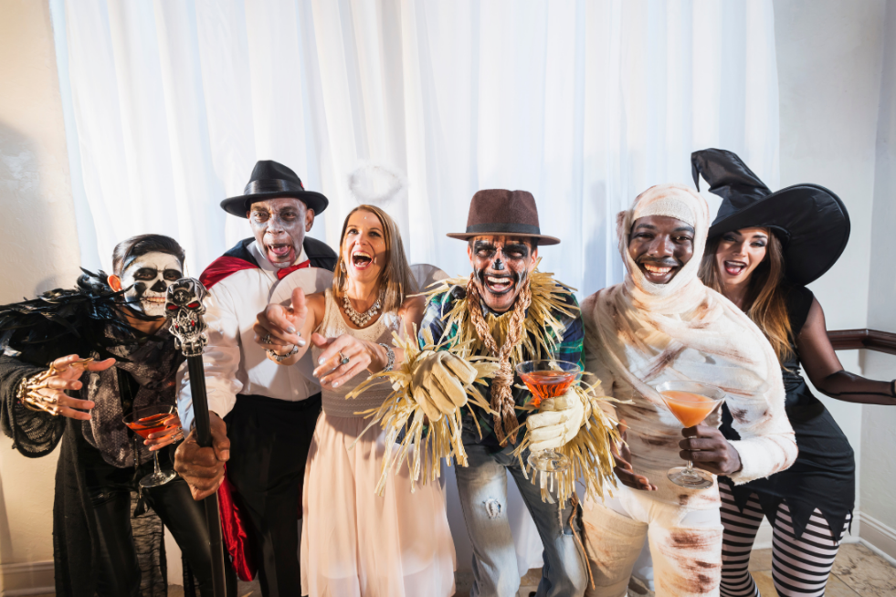 Adults smiling in Halloween costumes 