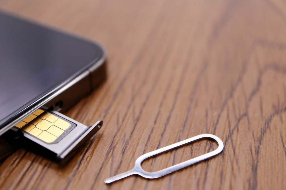 A SIM card and a SIM-eject tool
