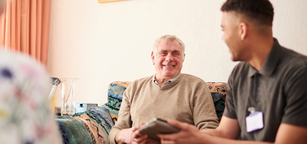 A carer chatting to an elderly client