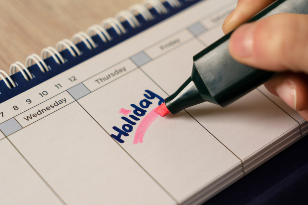 The word 'Holiday' handwritten into a calendar