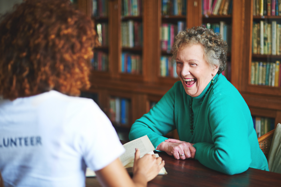 A woman sat at a table laughing