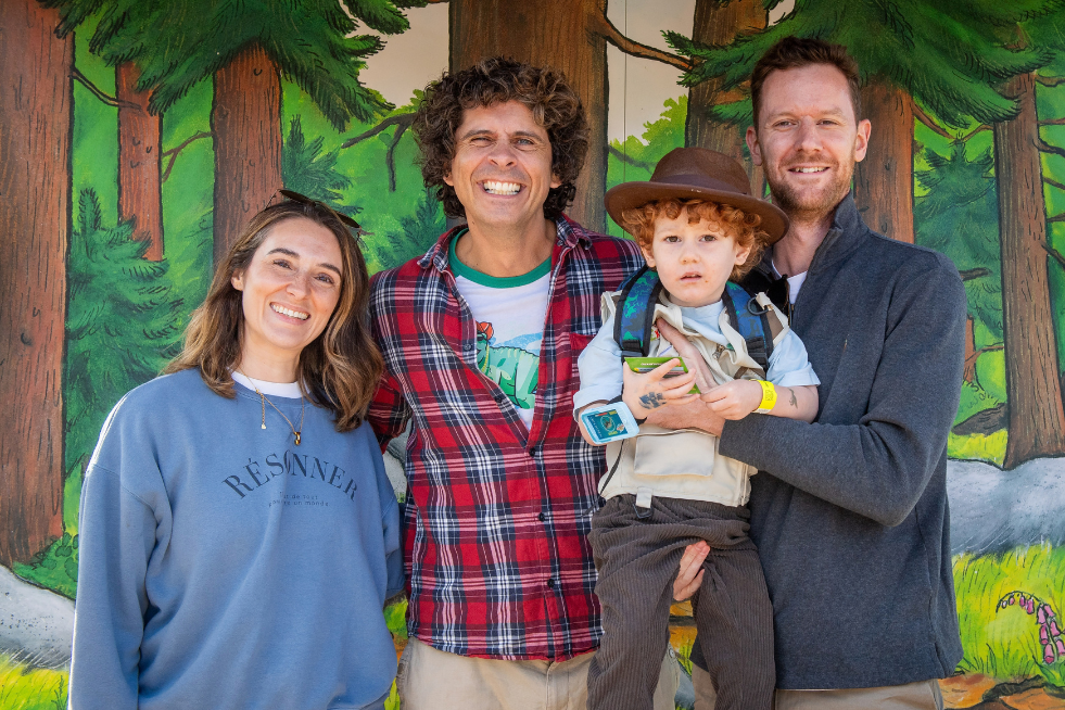 Andy Day posing with families