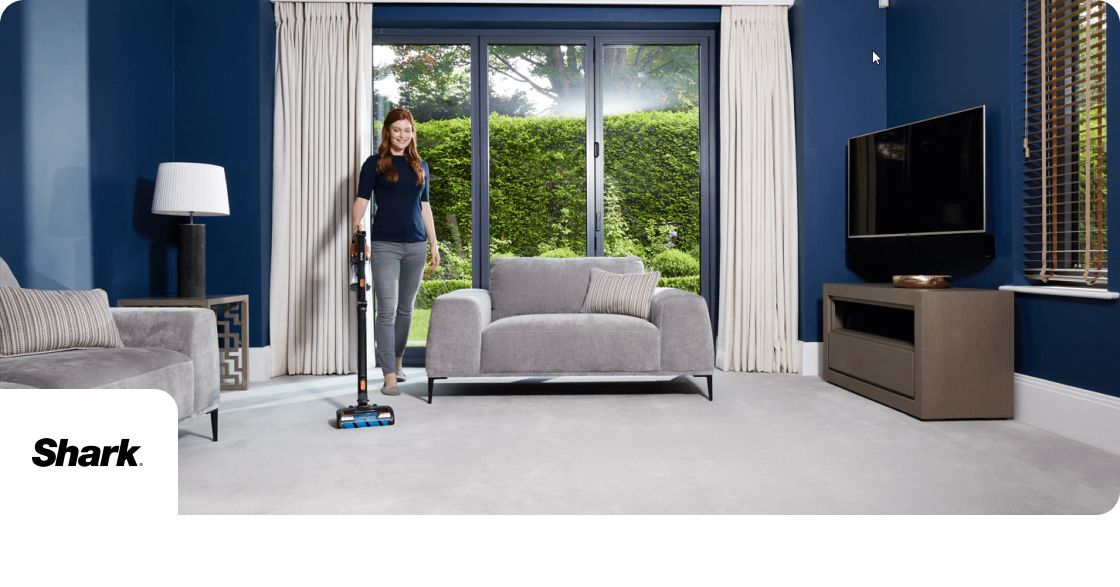SHark discounts banner image showing person vacuuming a room