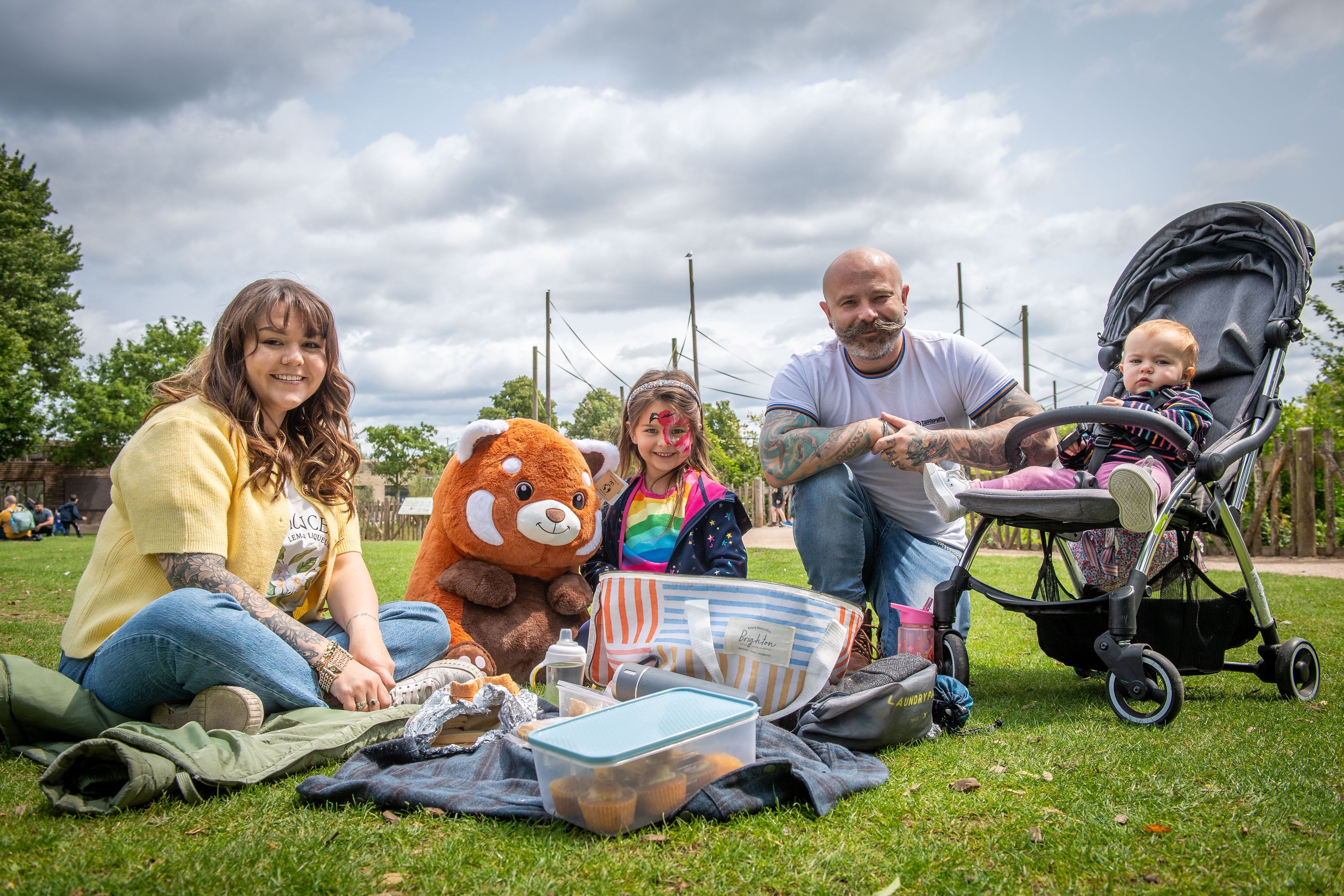 A family of four sat having a picnic at Twycross Zoo